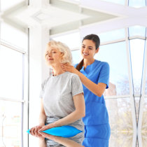 caregiver doing a massage to a senior woman